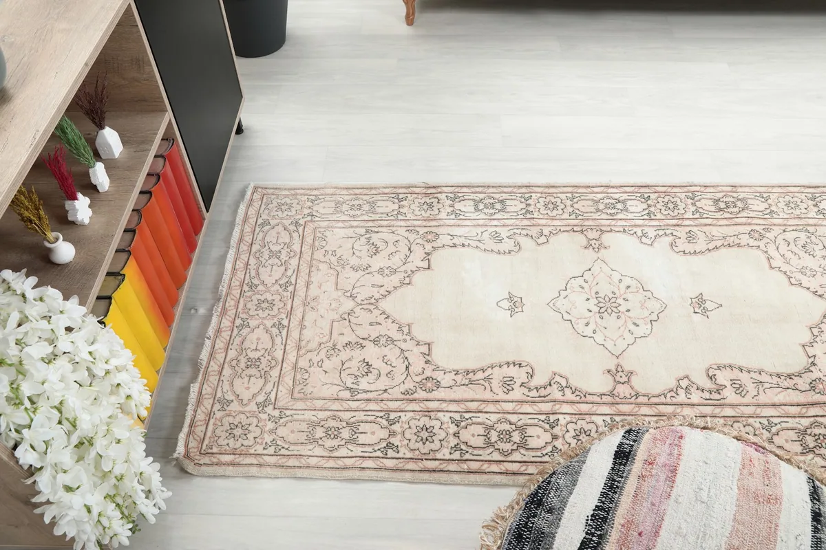 Side view of the rug in a room, showing its length and design flow
