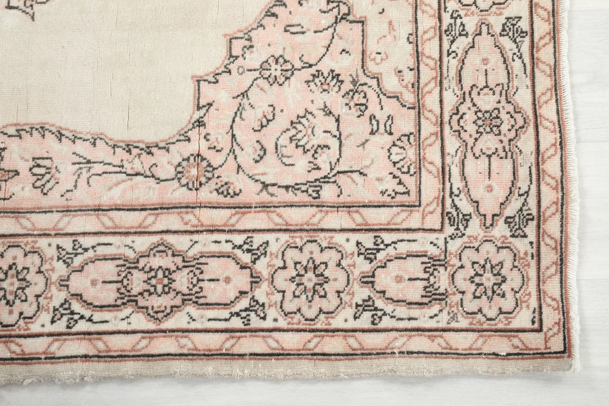 Detailed view of the corner border and floral patterns in rose and gray