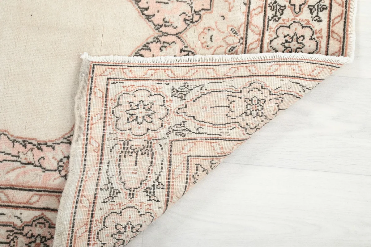 Underside of the rug, showing the cotton foundation and fine hand-knotting
