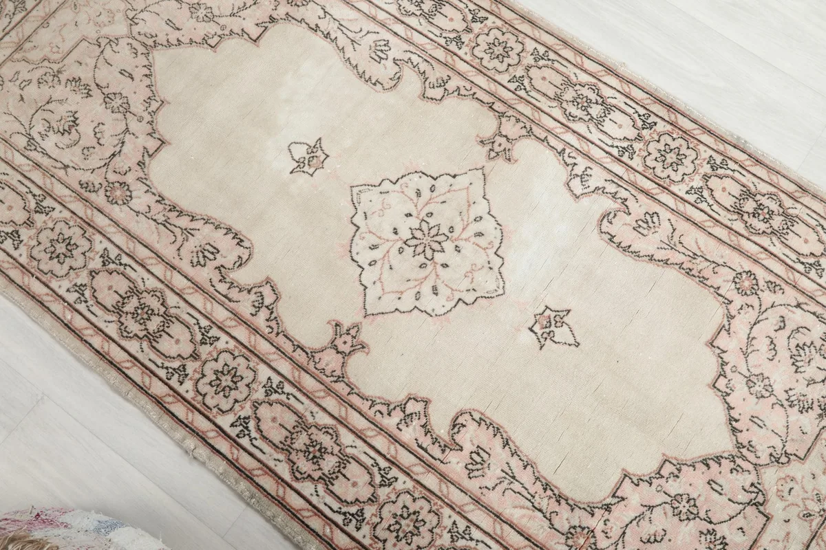Overhead view focusing on the central medallion and surrounding field of the rug