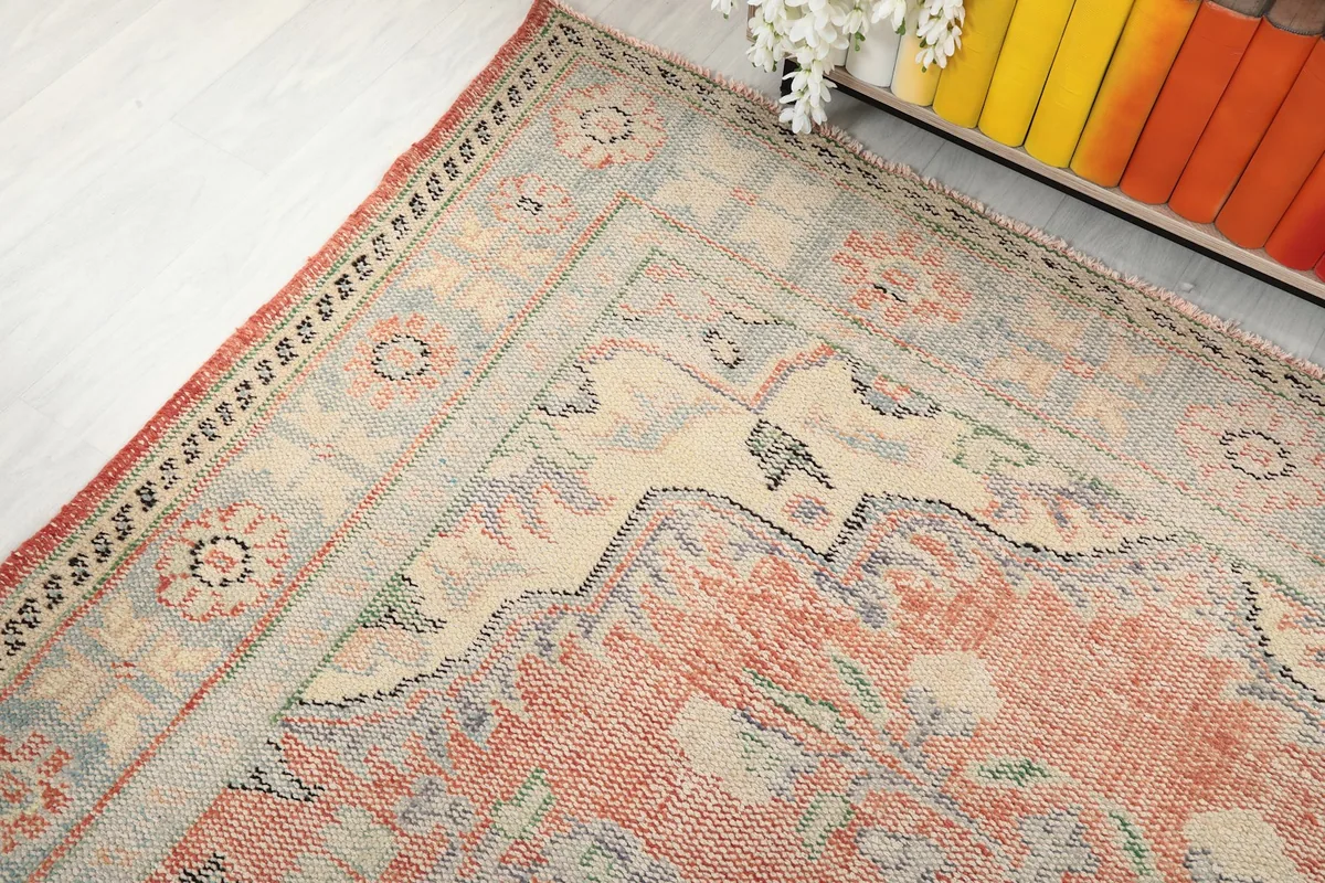 Corner view of the rug showing the border pattern and a subtle shift in color.