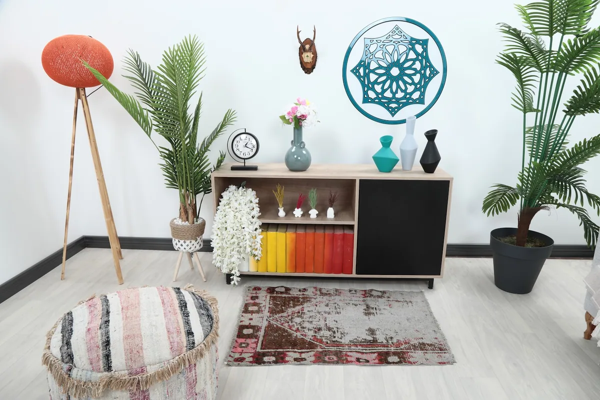Vintage gray and brown rug styled in a modern living space with furniture and plants.