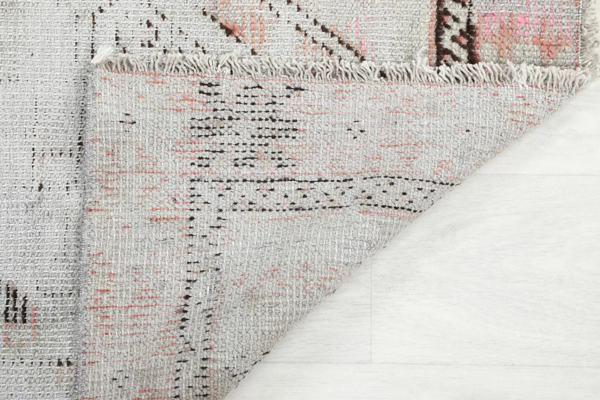 View of the back of the rug, revealing the hand-knotted construction