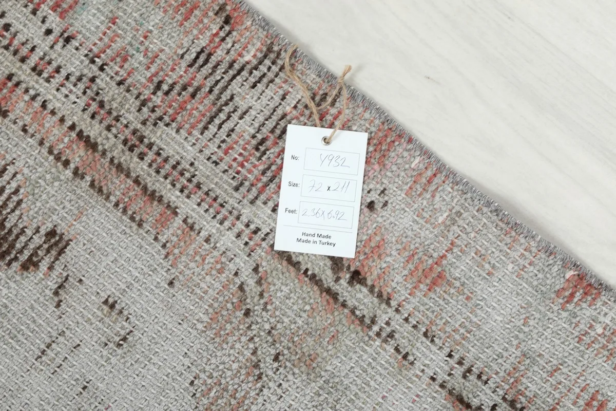Close-up of the care tag attached to the back of the vintage Anatolian runner rug