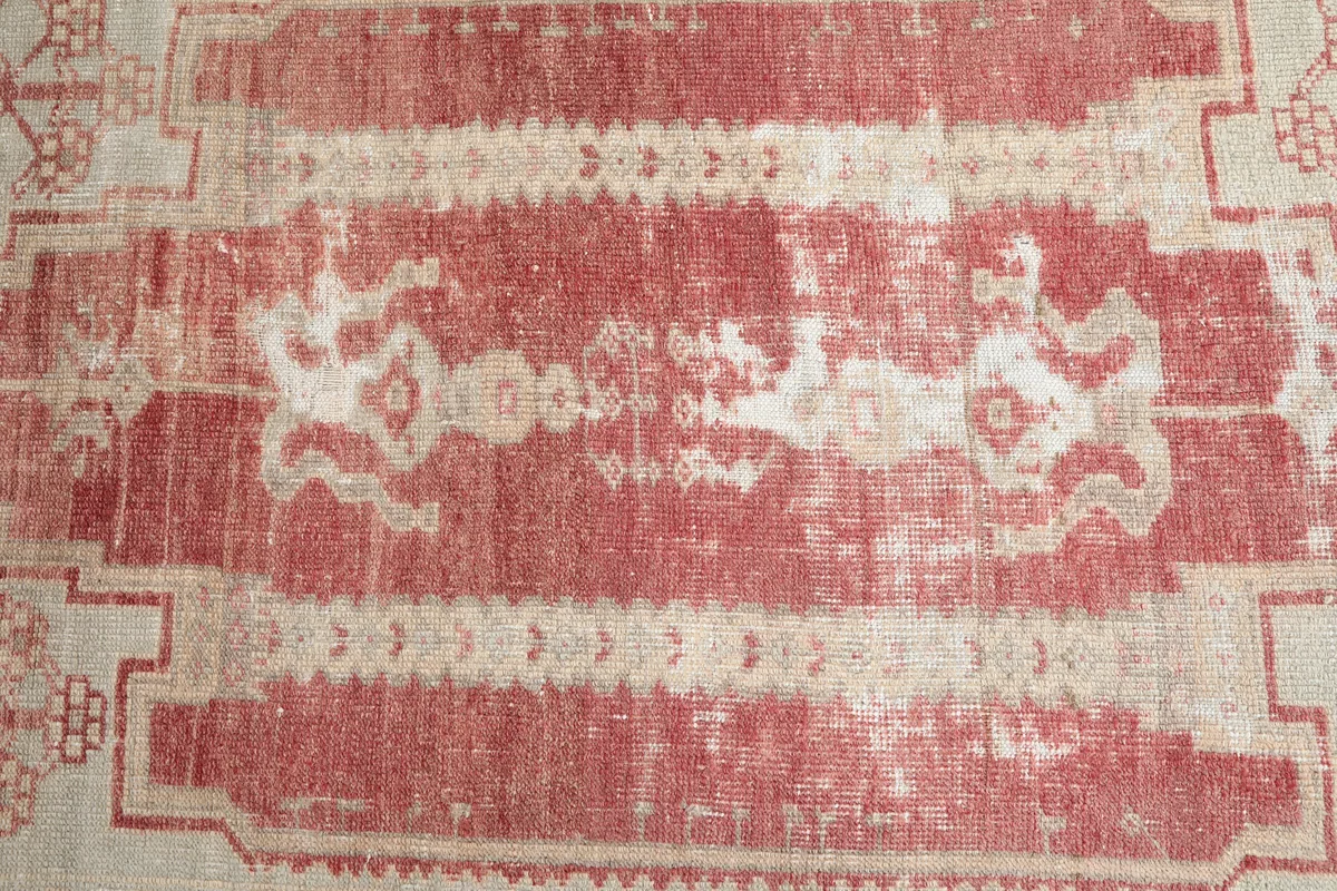 Close-up of the central geometric motif on the Faded Rose Geometric Anatolian Rug, showing the unique distressed effect.