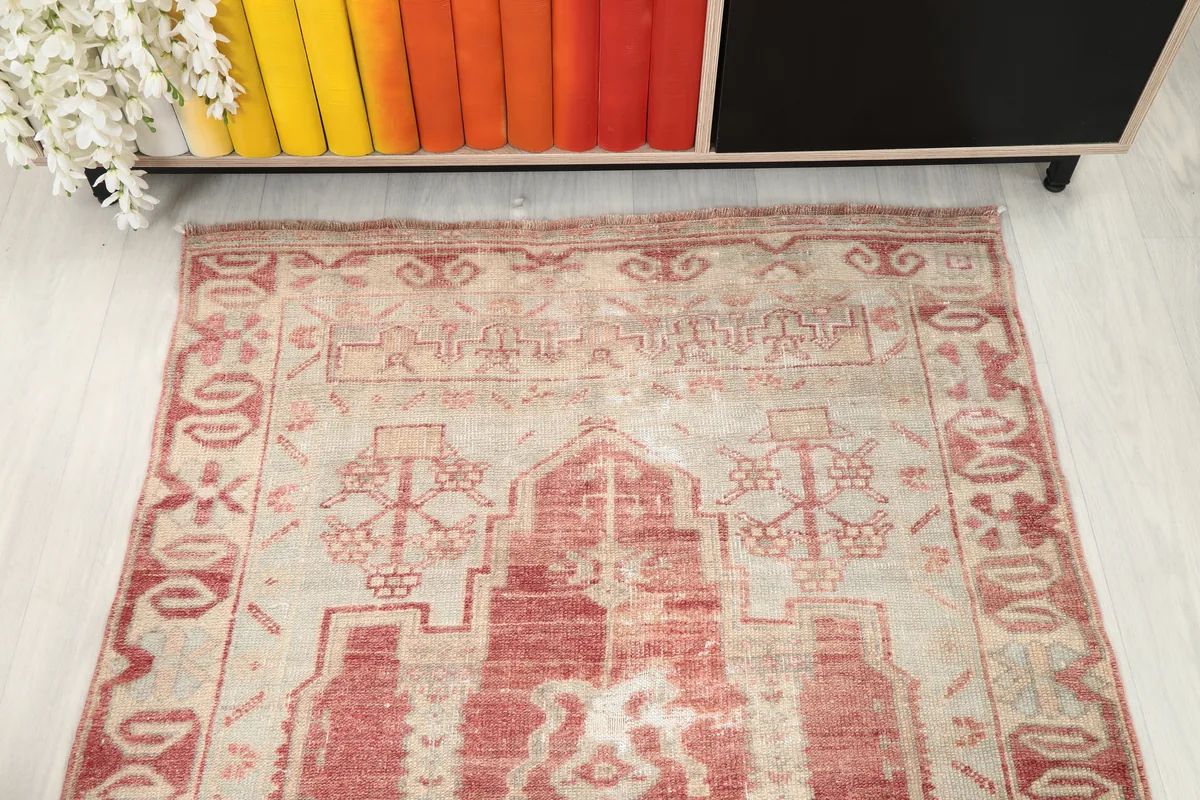 Top-down angled view of the Faded Rose Geometric Anatolian Rug, capturing the full pattern and color variations.