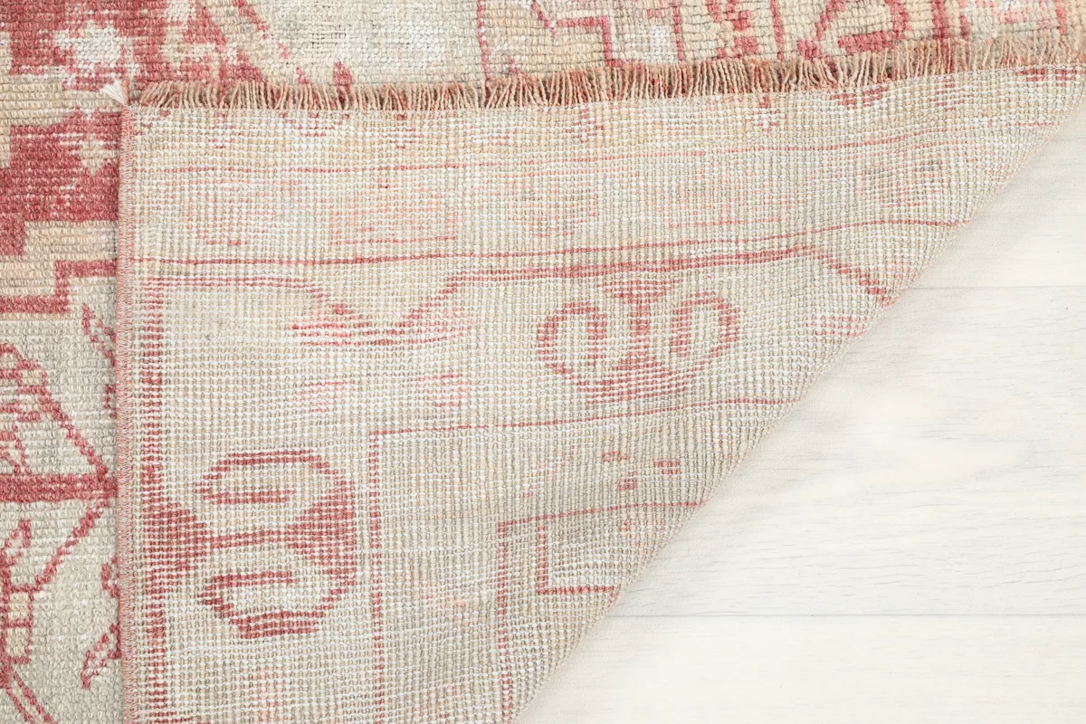 Underside view of the Faded Rose Geometric Anatolian Rug, showing the tight hand-knotted construction and fringe.