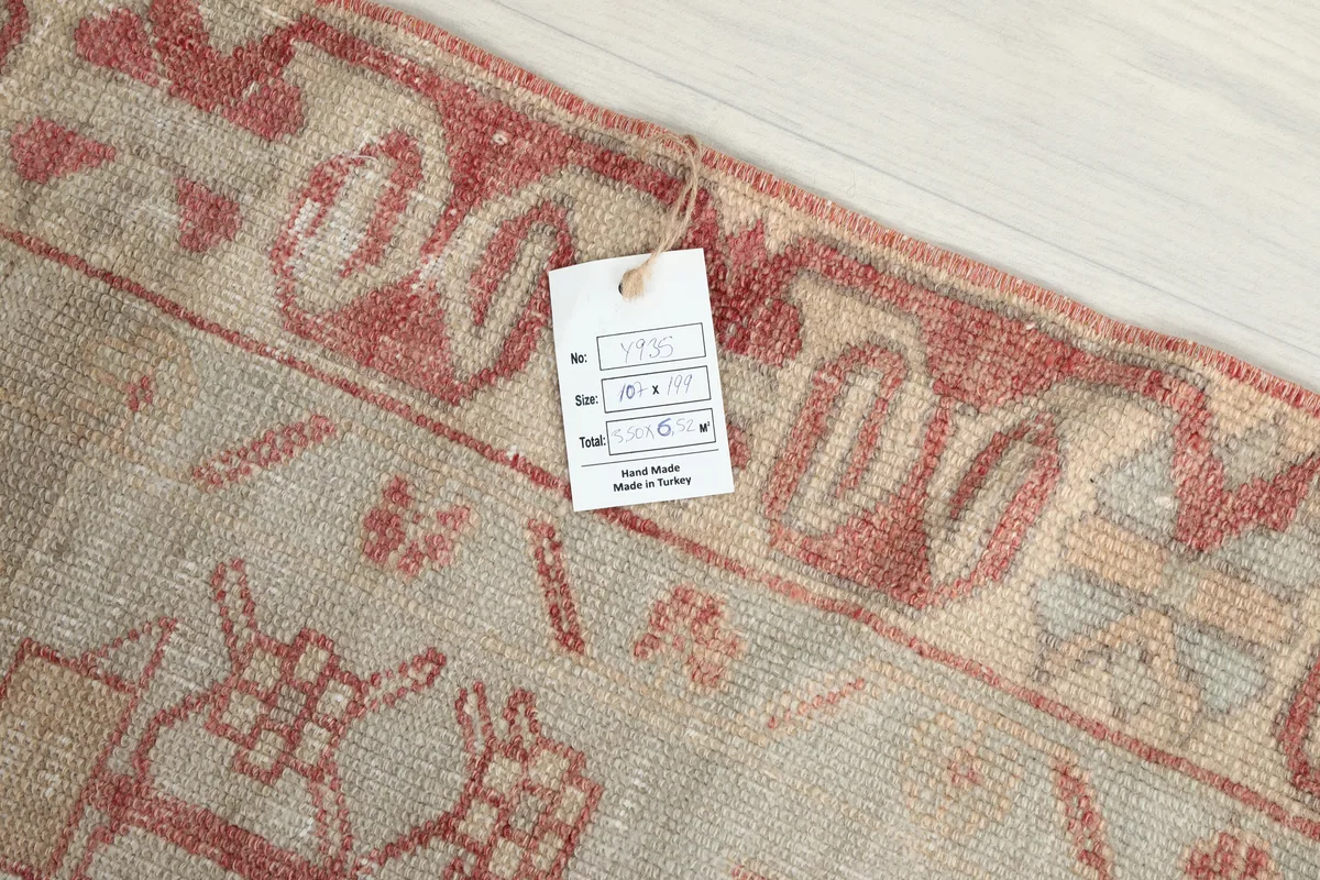 Product tag on the Faded Rose Geometric Anatolian Rug, confirming its hand-made origin in Turkey and size.