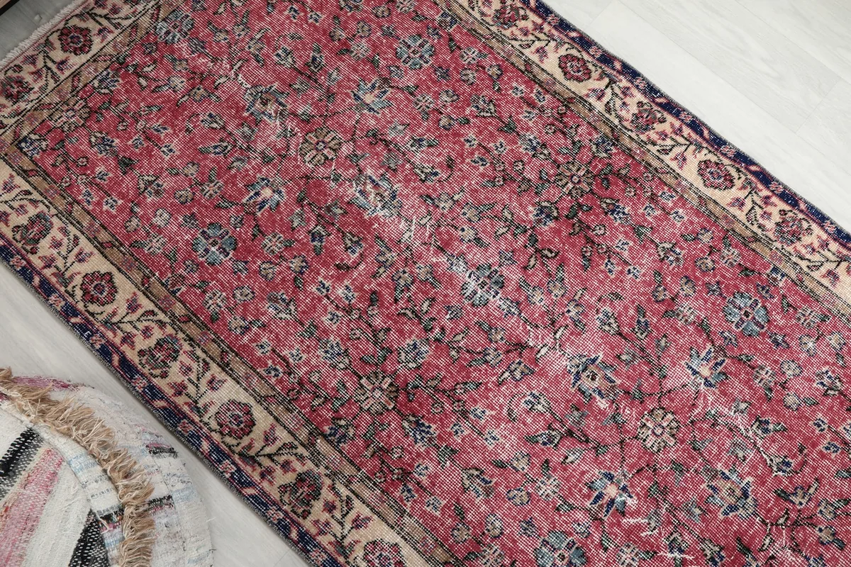 Overhead angle view of the rug, emphasizing the overall design and faded rose colors