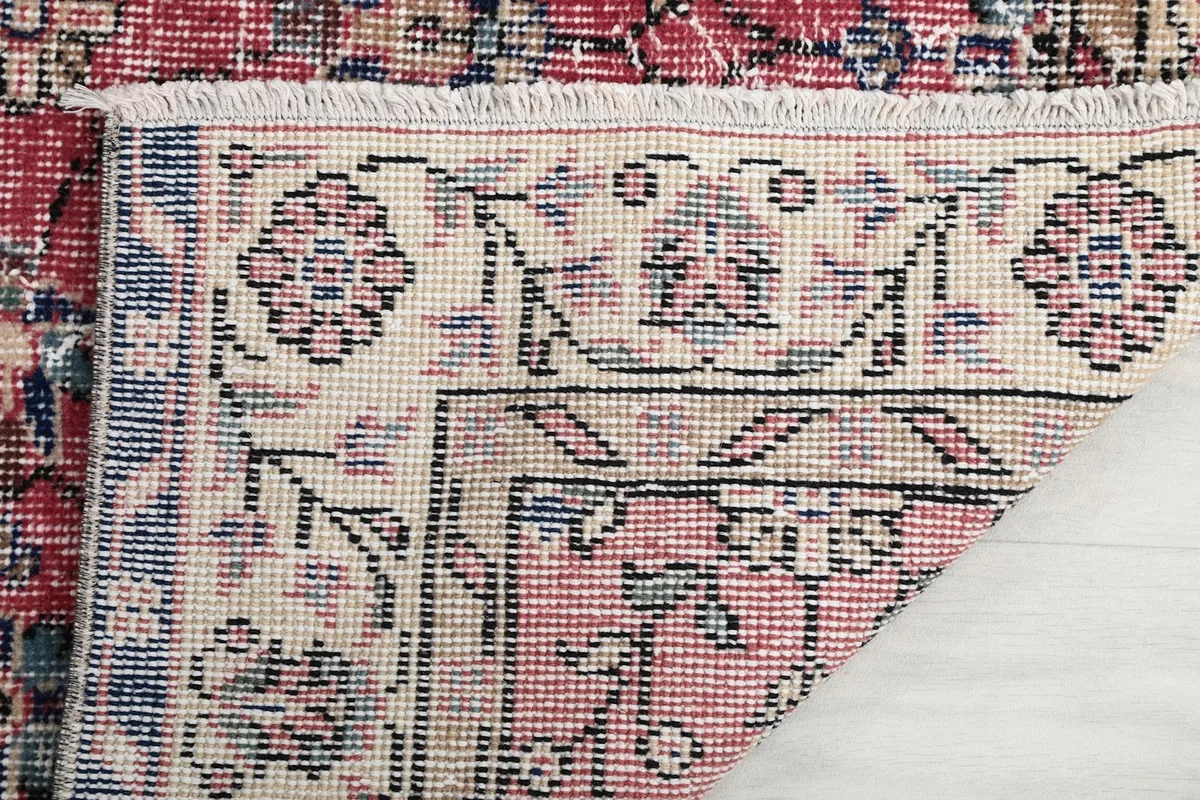 Close-up of the rug's reverse side, showing the tight hand-knotting and cotton foundation