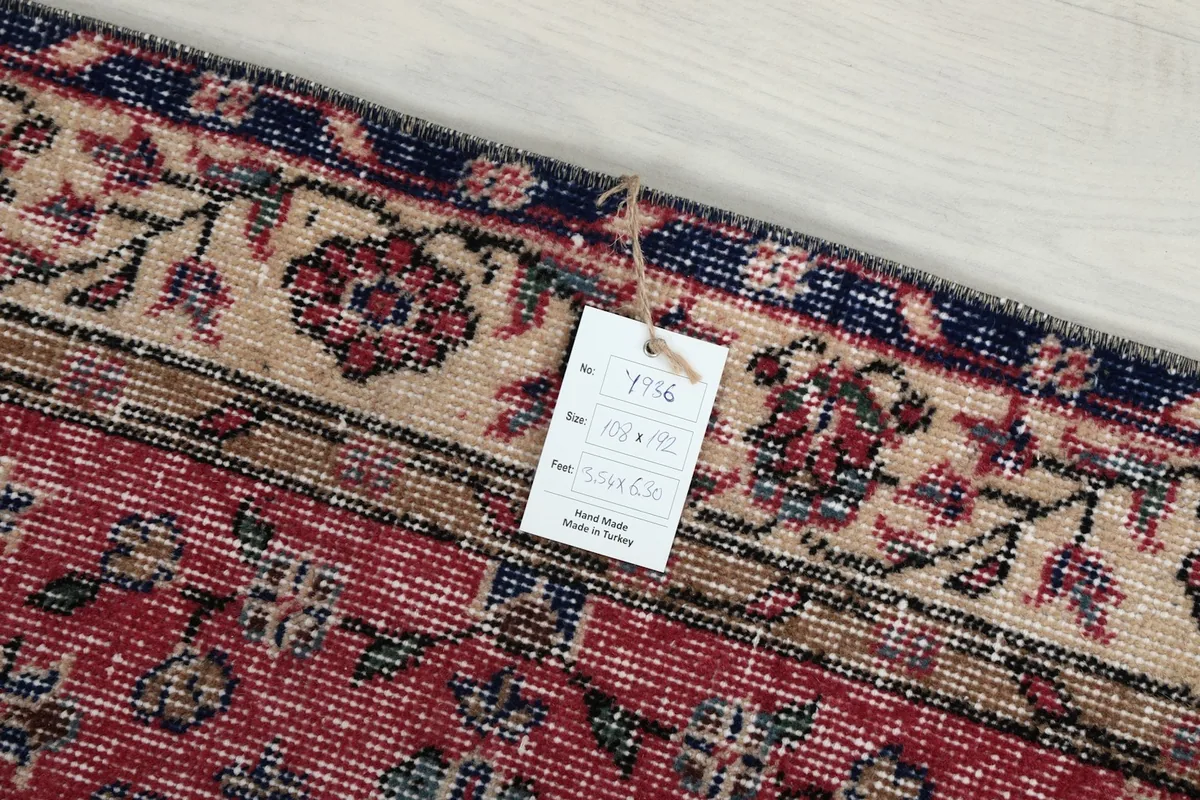 Information tag attached to the rug, displaying details about its origin and dimensions