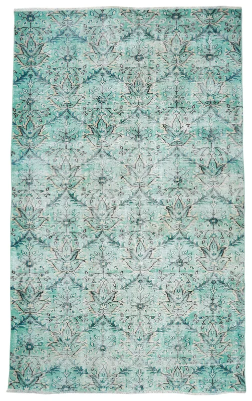Full overhead view of the green floral geometric vintage Anatolian rug