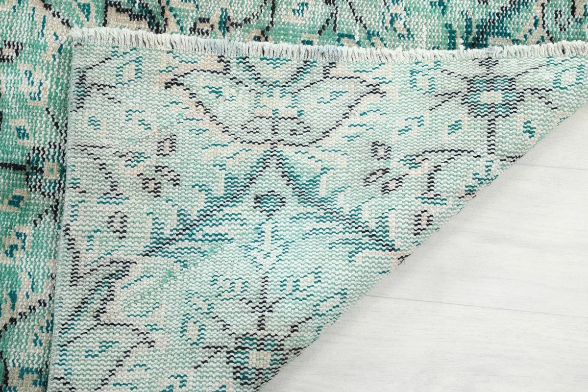 Detailed view of the rug's cotton foundation and reverse side of the knotting