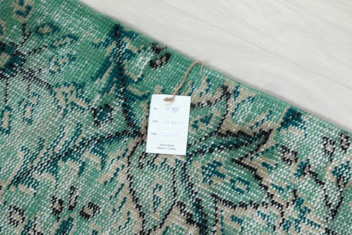 Close-up of the product tag attached to the vintage Anatolian rug