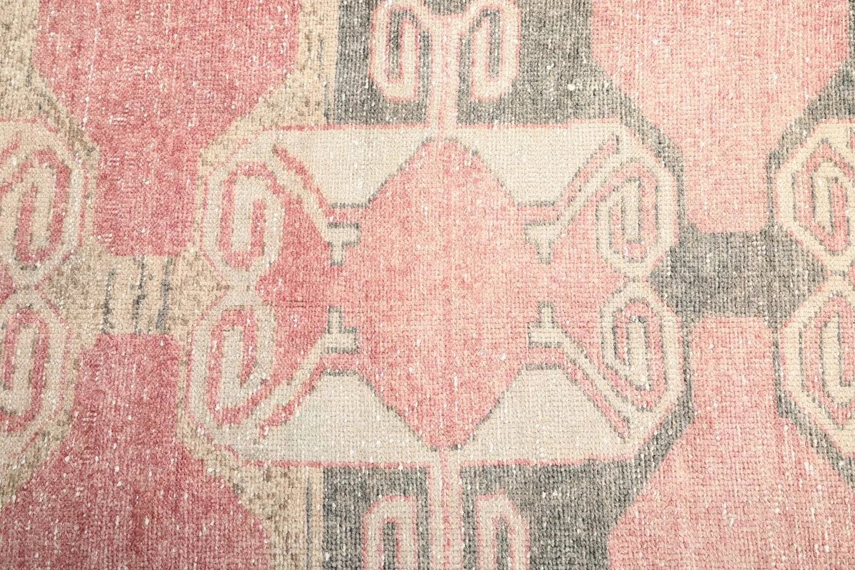 Detailed close-up of a central geometric motif on the runner, showing the hand-knotted wool texture.