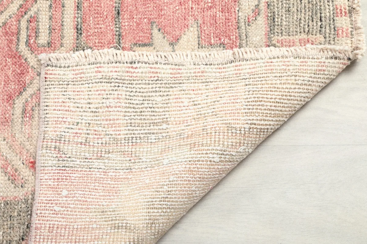 Close-up of the back of the rug, showing the consistent hand-knotted construction and cotton foundation.