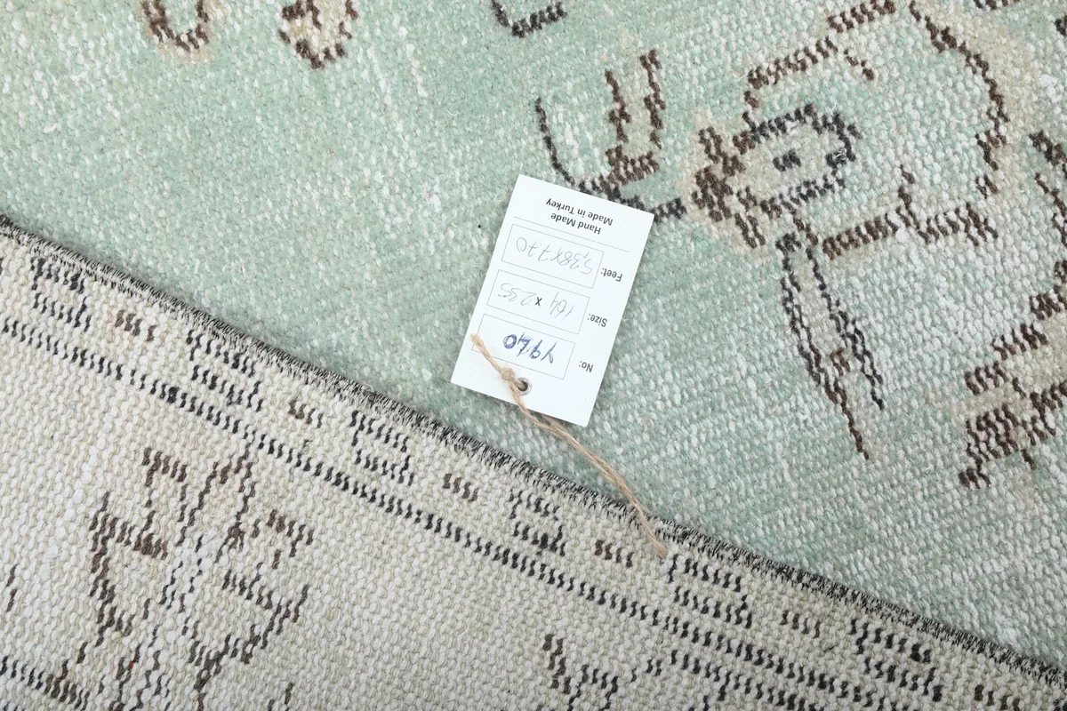 Product tag on the back of the rug, detailing its origin and material
