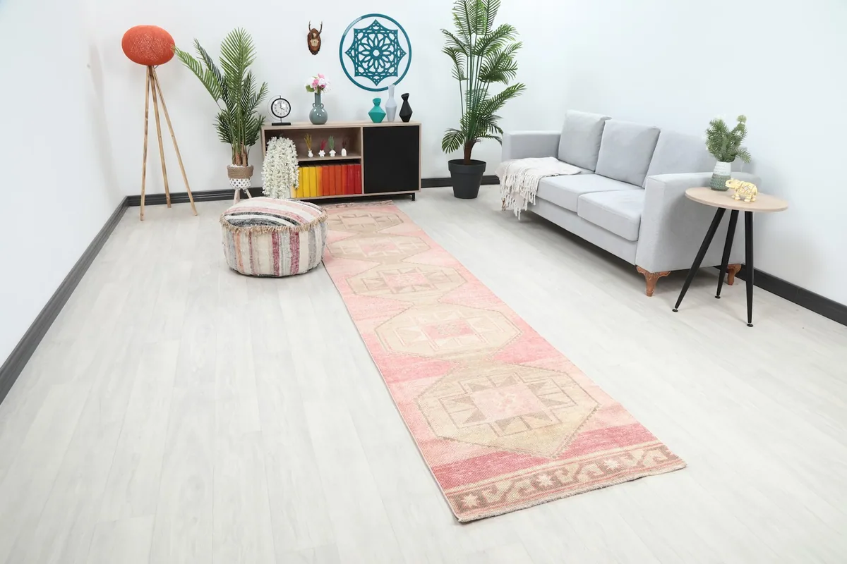Long view of the rose and tan runner rug extending through a living space
