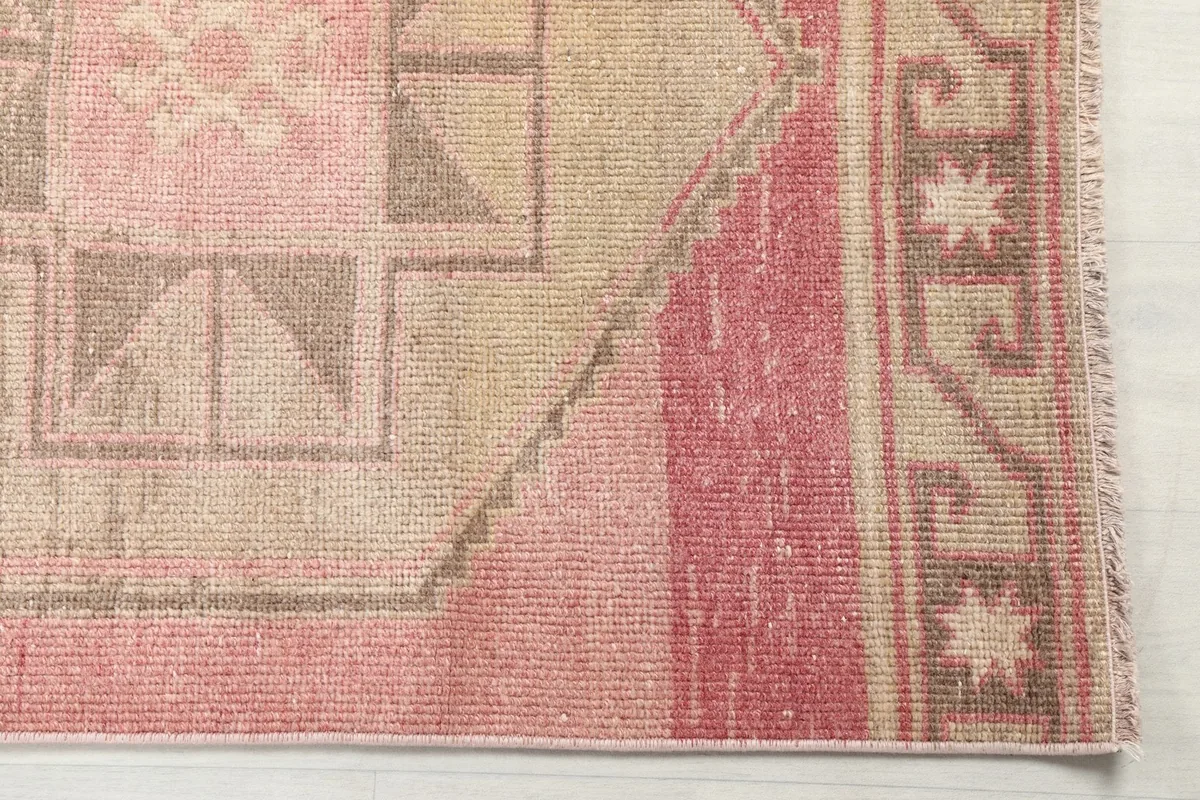 Close-up of the runner's end, showing rose field and geometric border details