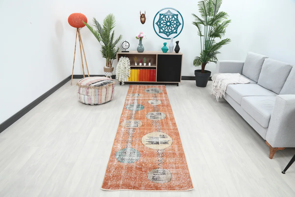 Rust Geometric Oval Runner in a modern room setting, showing its length and design alongside furniture.