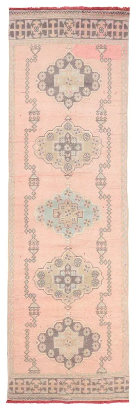 Full top view of a 3x10 rose geometric vintage Anatolian runner rug on a white background.