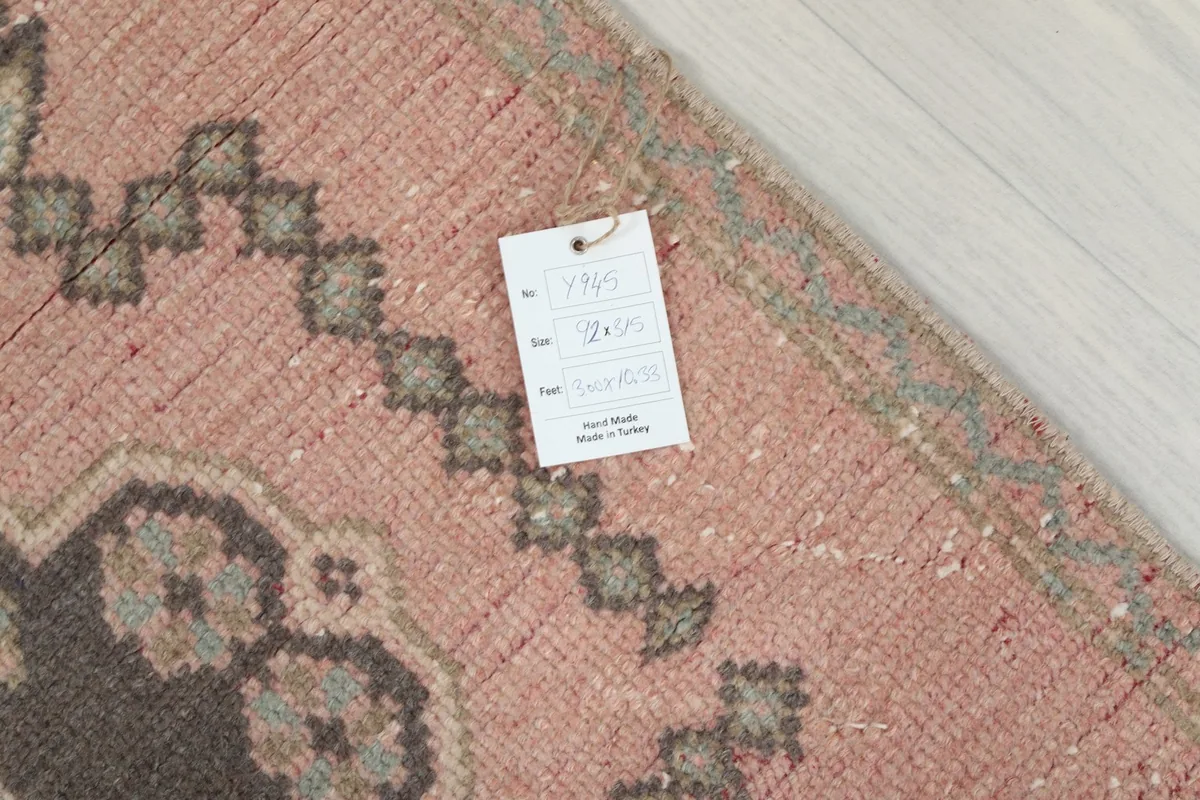 Close-up of the rug's texture and a product tag, indicating its origin and material.