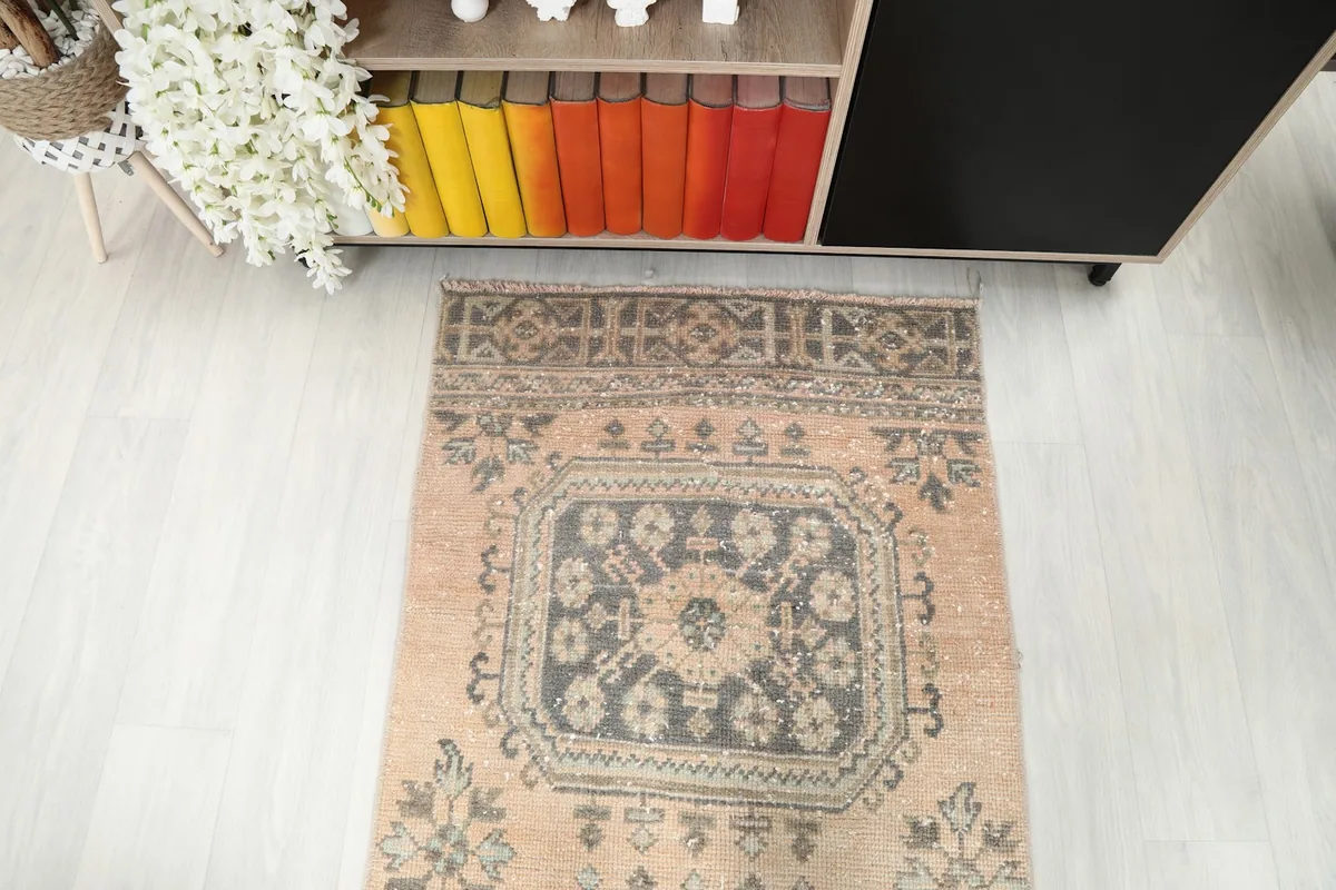 Overhead view of the lower section of the runner rug, showcasing the charcoal and tan patterns.