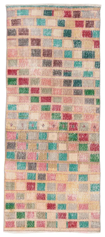 Full top view of the multicolored geometric patchwork runner on a white background