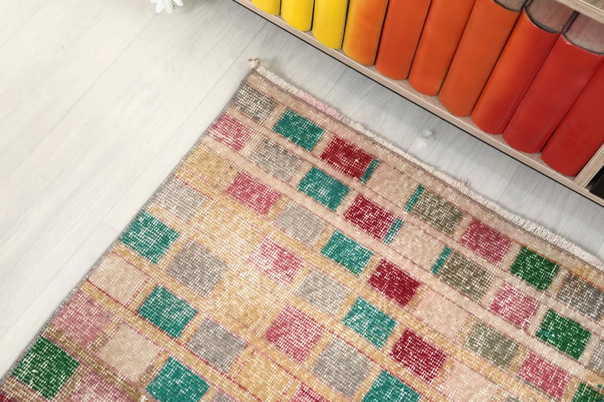 Top-down angle of the runner rug showing its placement near a colorful bookshelf