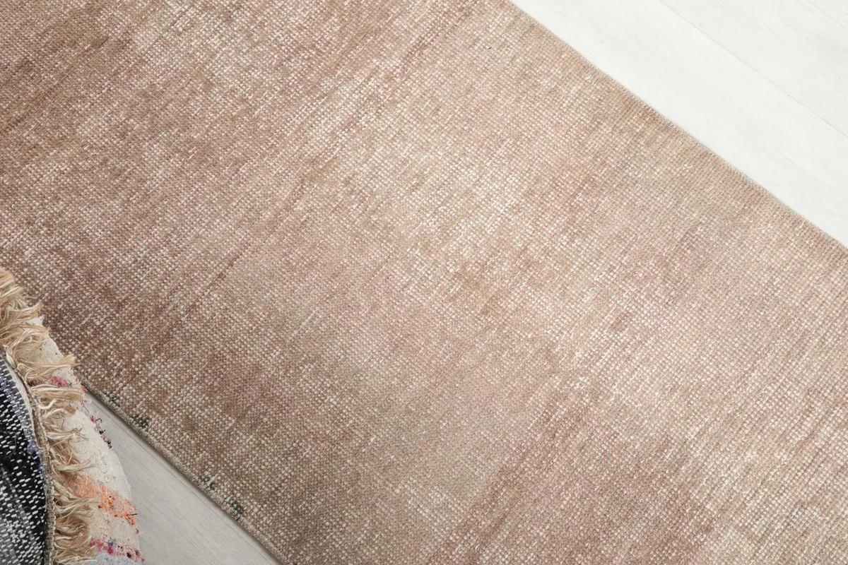 Overhead angle shot of the runner's beige field, revealing the subtle variations in color and texture