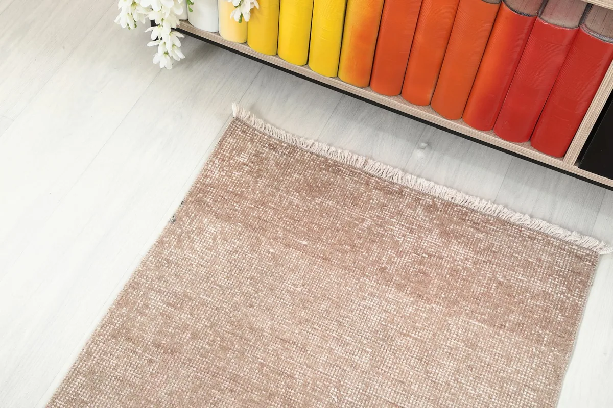 Overhead view of a section of the runner rug in a room, showcasing its color against light flooring