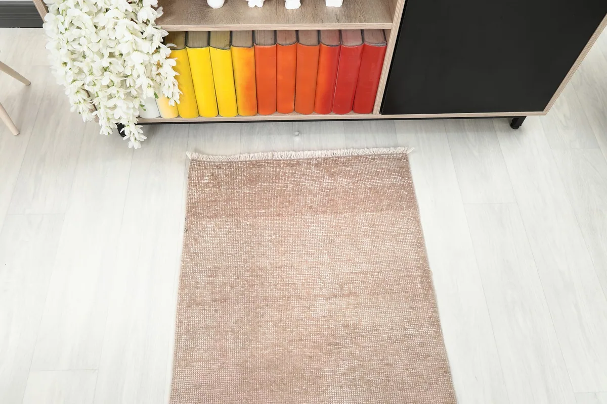 Straight overhead view of a portion of the runner rug, emphasizing its uniform beige tone