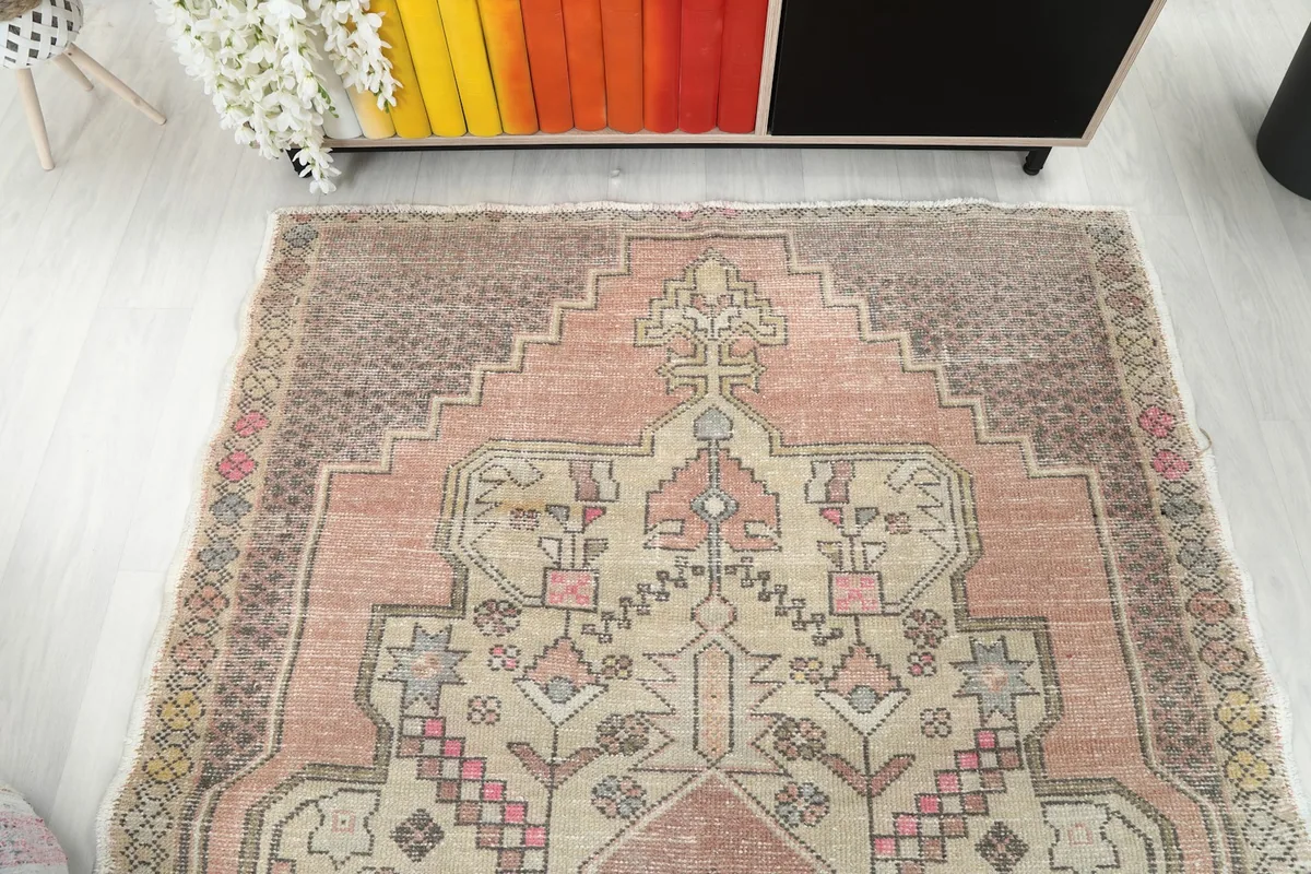 Overhead view of one end of the rug, highlighting the symmetrical geometric design and color variations.