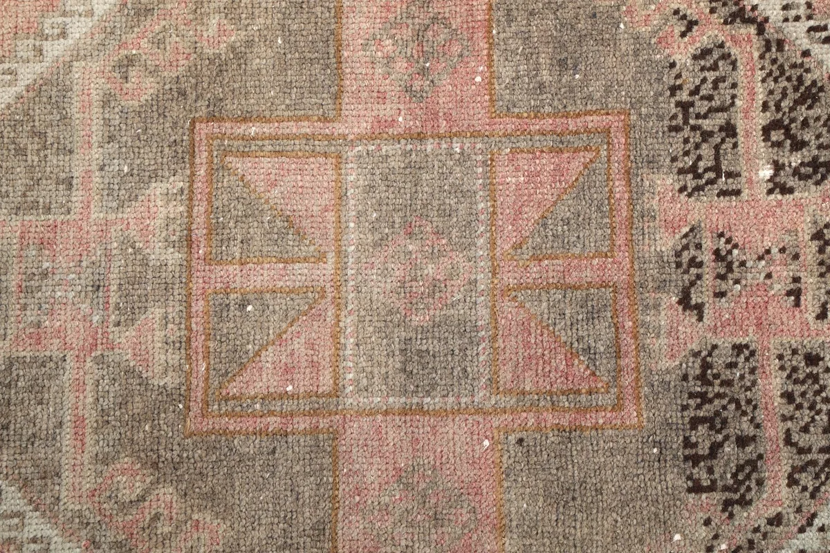 Close-up of a central geometric motif within the runner, showing wool texture