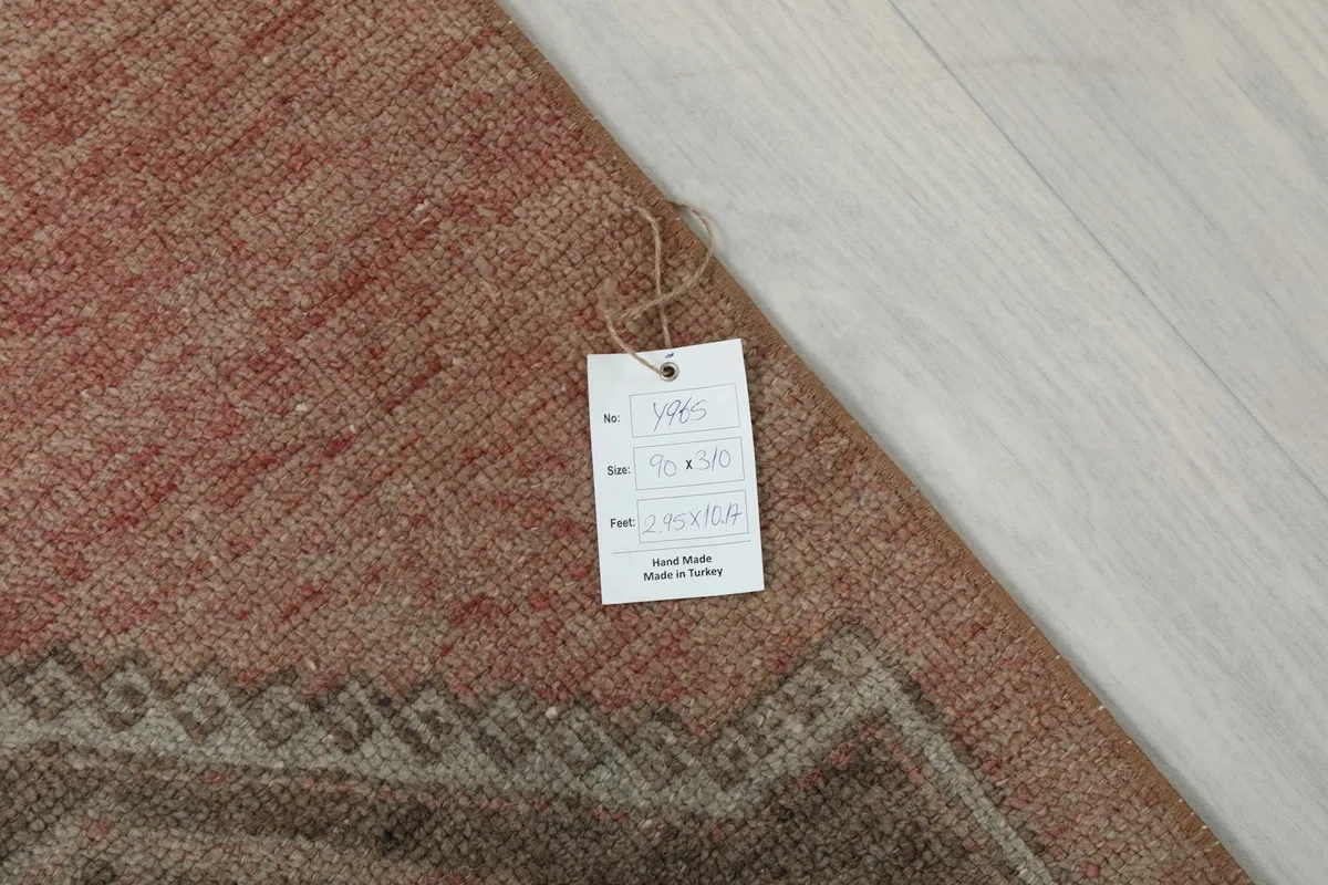 Close-up of the rug with a tag showing its dimensions and origin