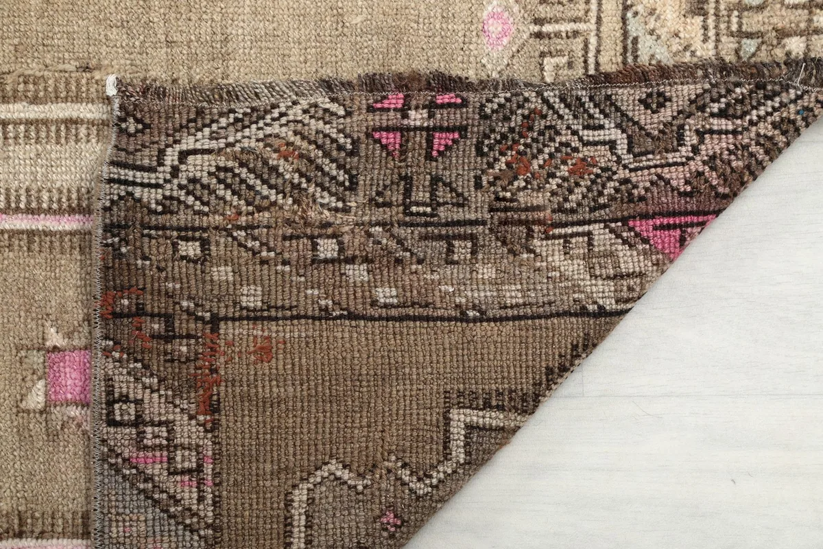 Detailed close-up of the low wool pile and the intricate knotting on the rug's surface.