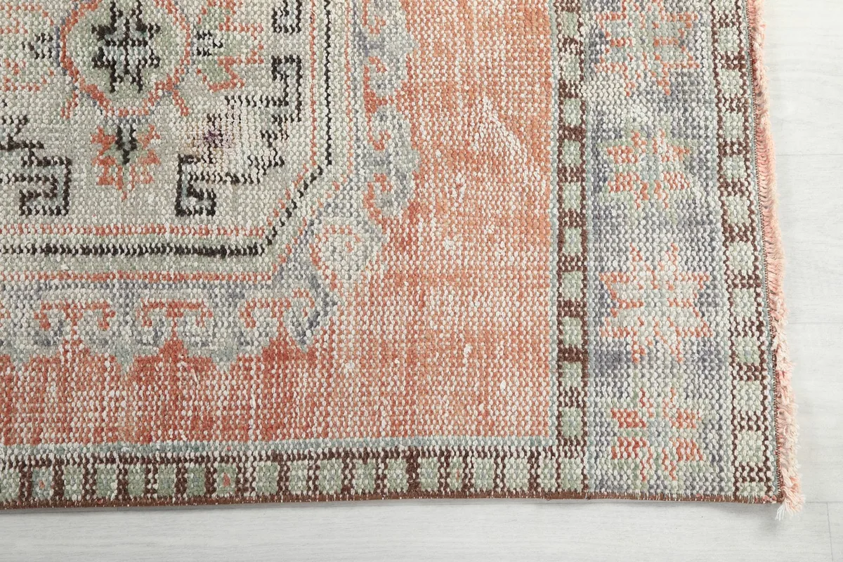 Detail of the runner's border and a geometric medallion with gray and black tones