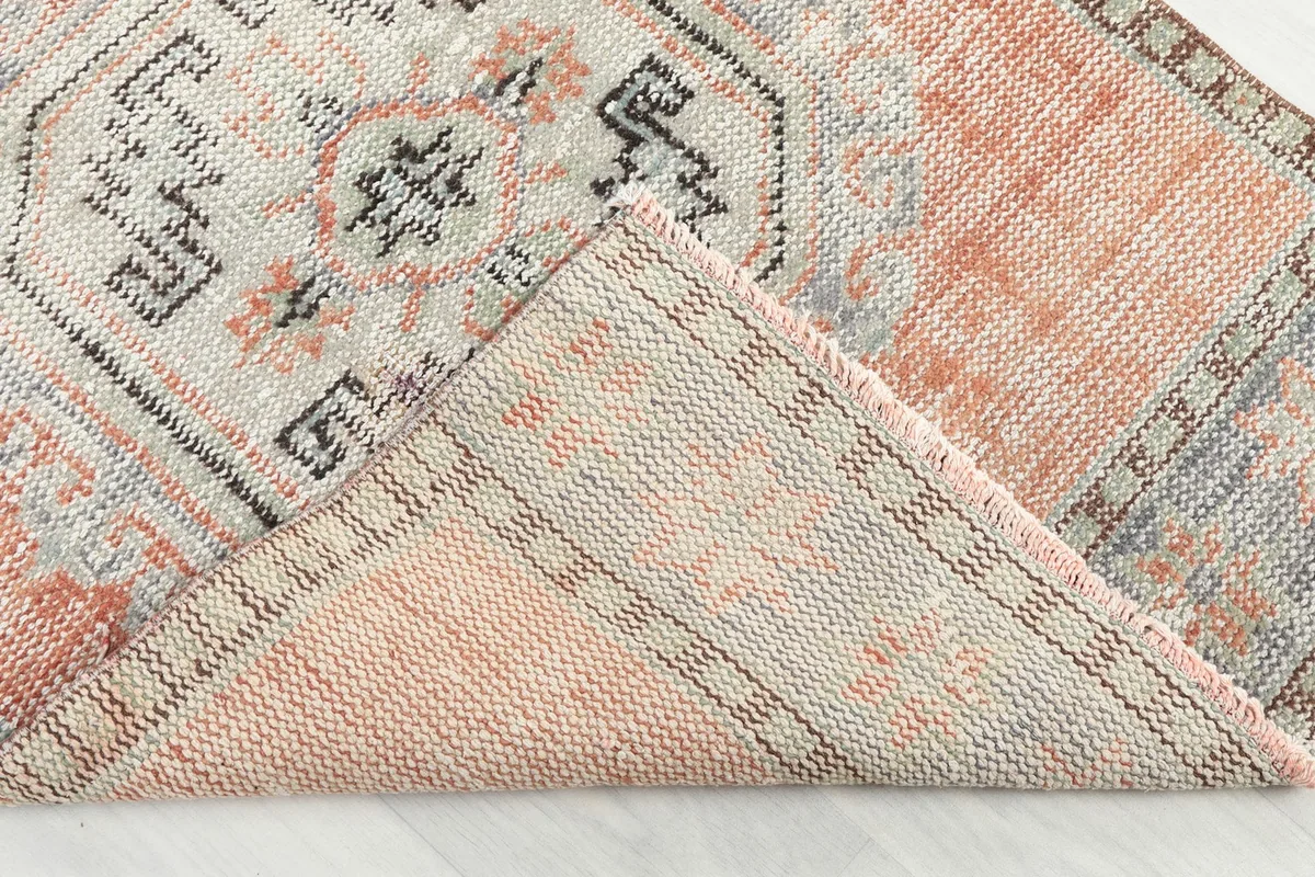 Folded corner of the rug revealing the backside and construction detail