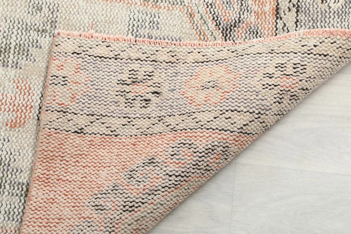 Underside of the hand-knotted rug, showing the cotton foundation and tight knotting