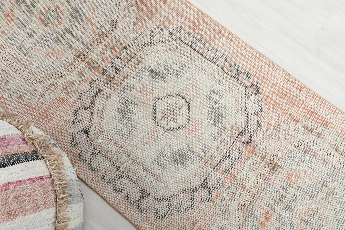 Overhead view focusing on a central geometric medallion and the surrounding faded rust area
