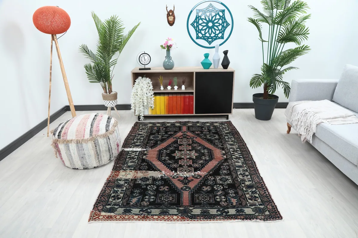 Vintage Anatolian rug with rose medallion and black field in a modern living room setting