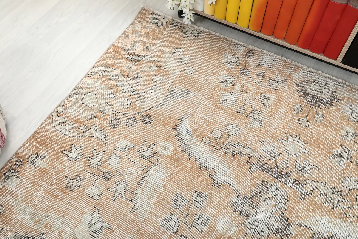Another angle showing the rug's surface, reflecting light and revealing the varied tones of beige and blue