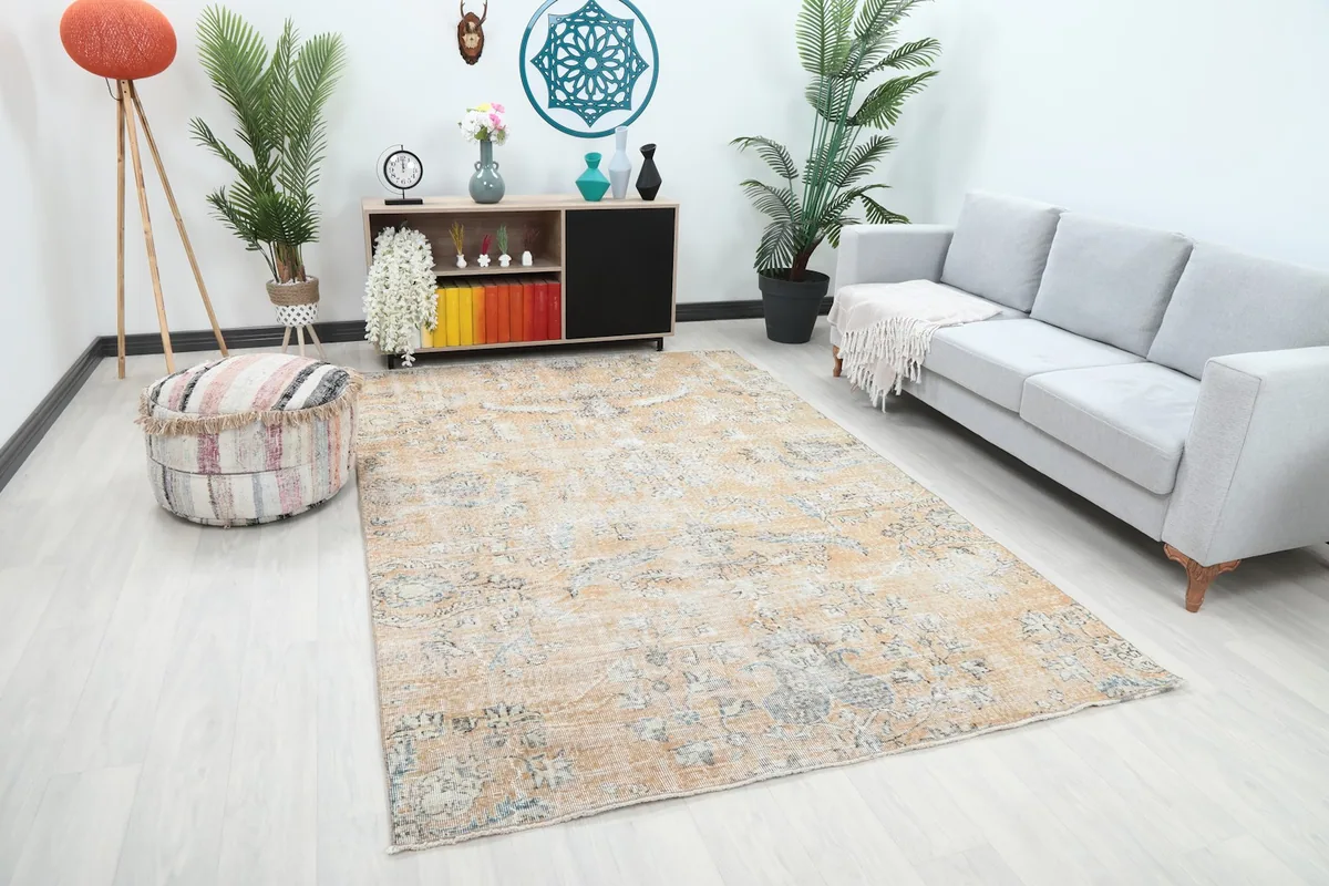 Angle view of the hand-knotted rug in a living space, showing its size and color harmony with the decor