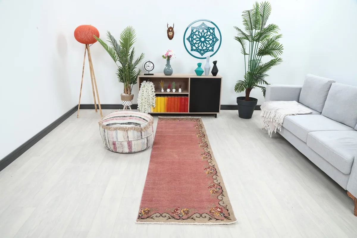 Pink runner rug on a light floor in a modern room setting