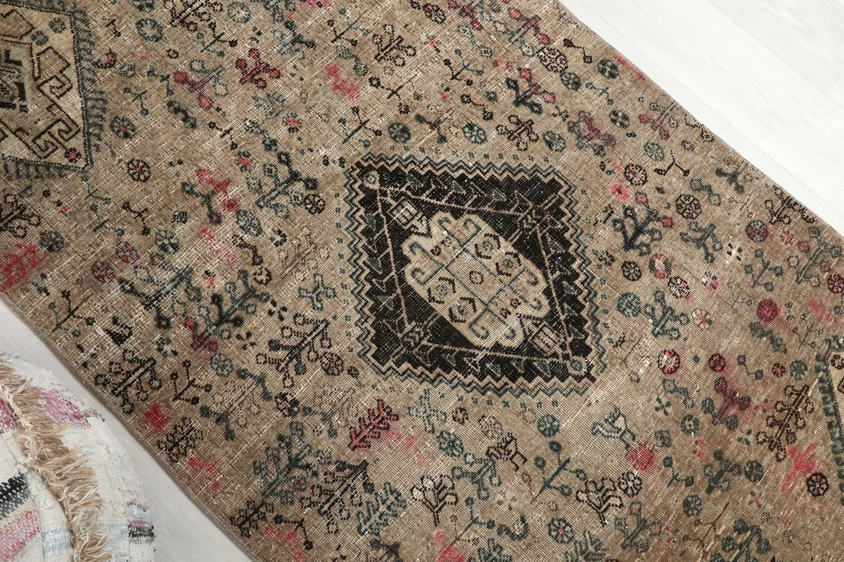 Overhead angle view highlighting the varied colors and geometric details of the rug