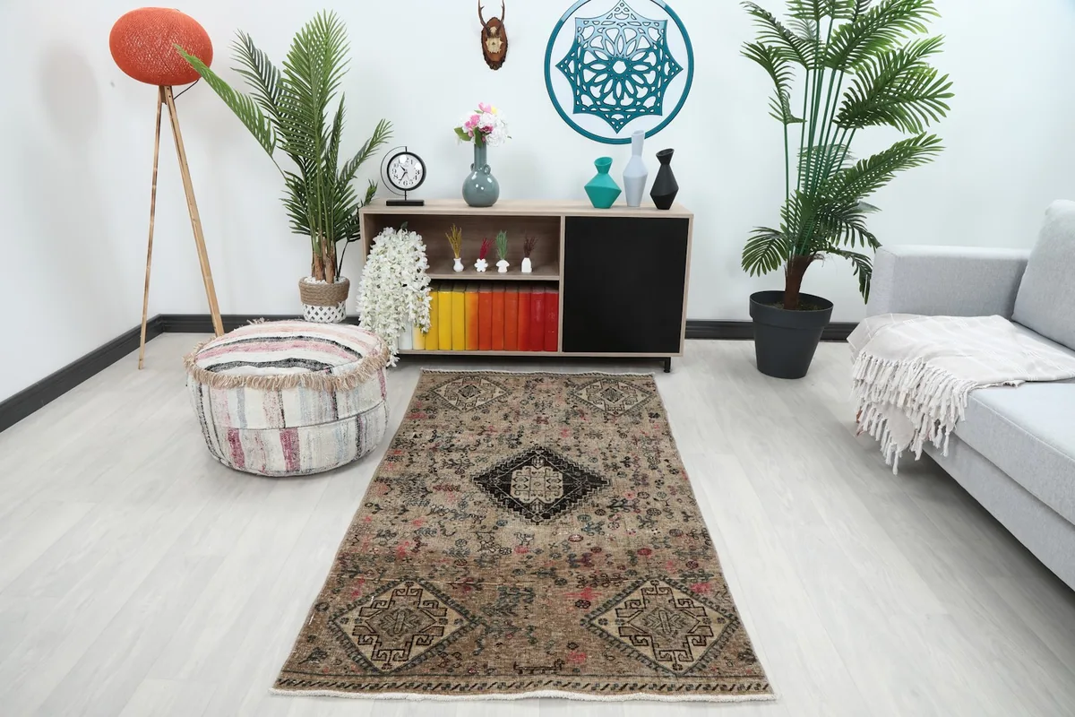 Beige tribal geometric rug in a modern room setting from an overhead angle