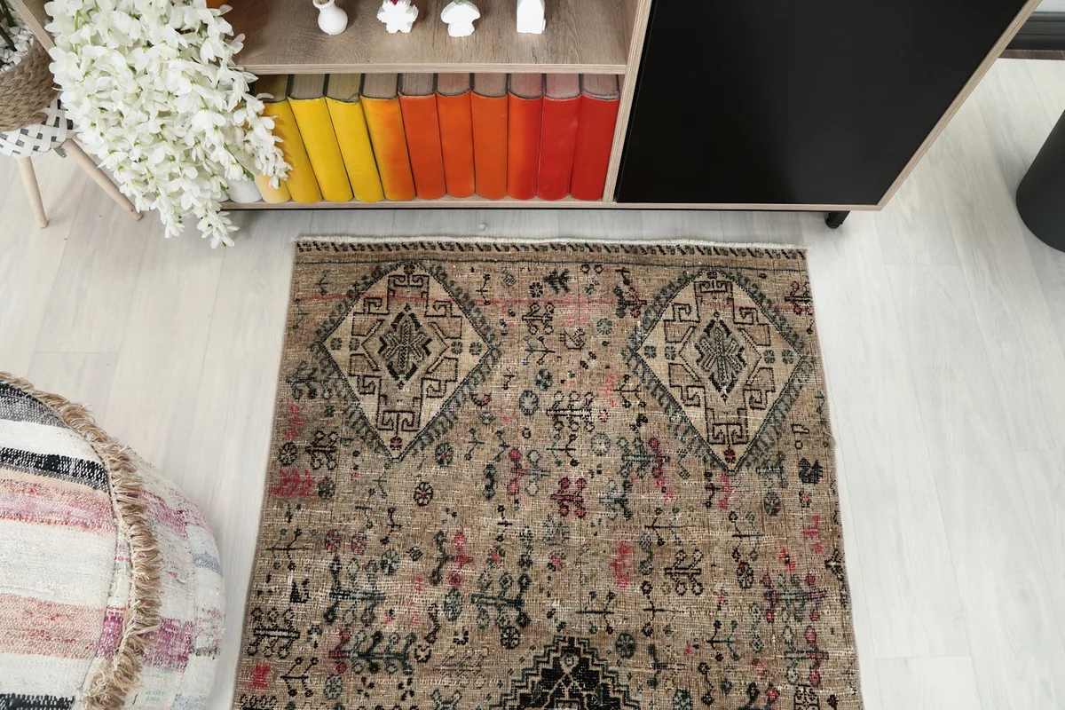 Overhead view of the beige tribal rug with its distinct geometric patterns in a room