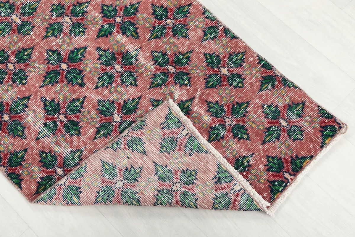 Folded corner of the runner rug revealing the cotton foundation and reverse side