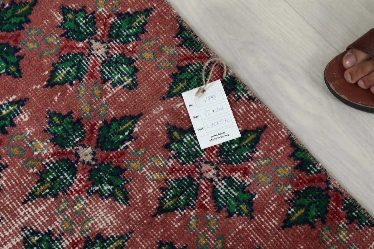 Detail of the rug with its product tag, confirming origin and material