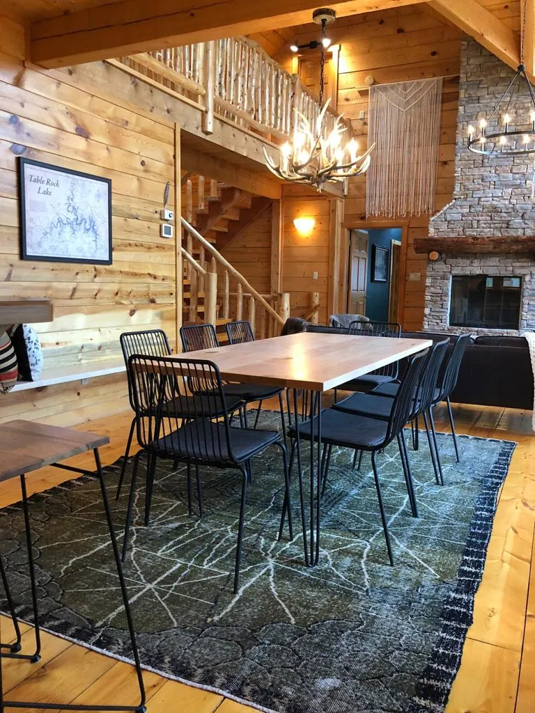 Green vintage rug under a dining table in a cabin